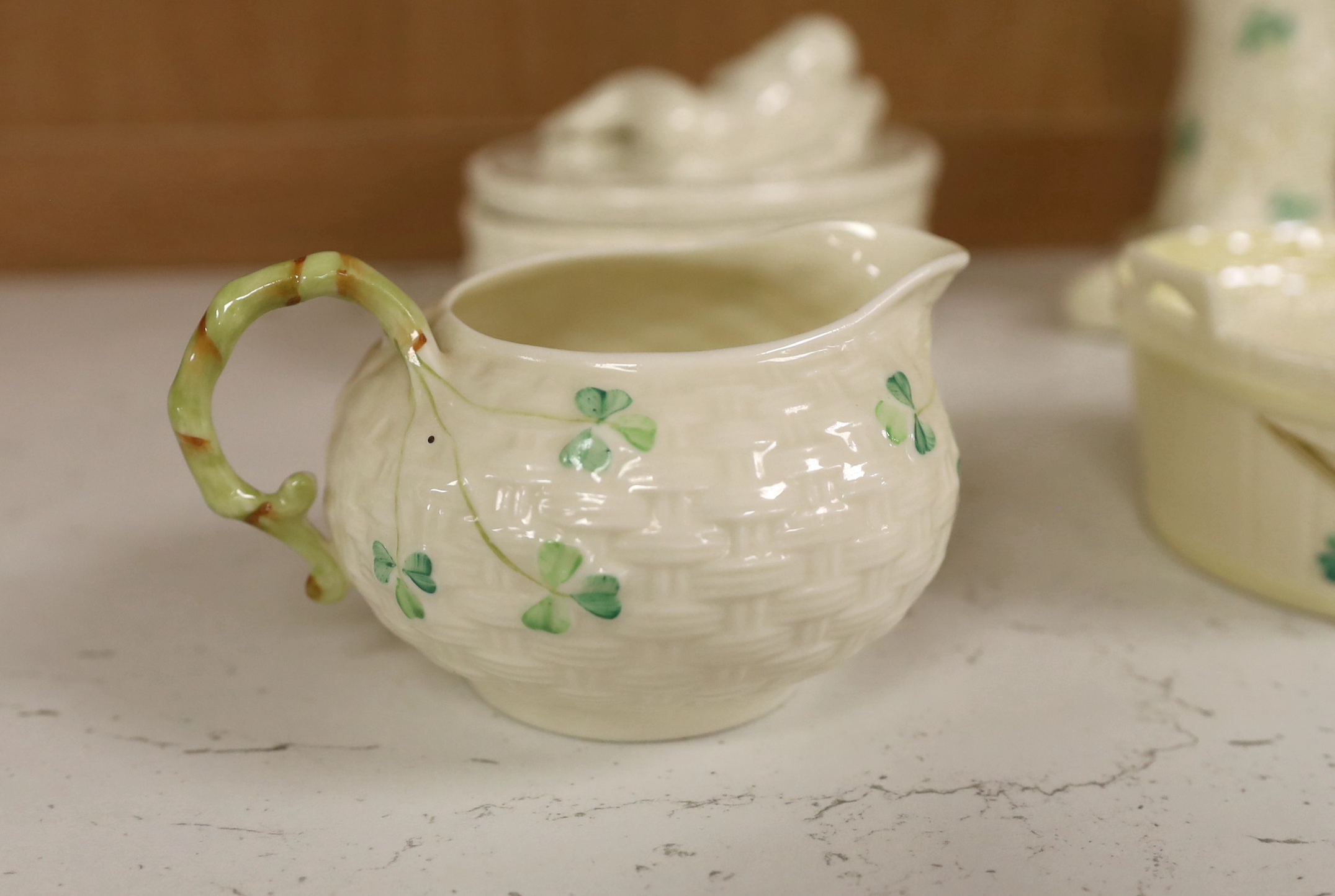 A quantity of Belleek ‘Clover’ pattern ceramics and a Belleek box and cover, tallest 18.5cm